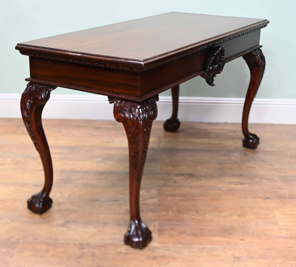A rectangular Chippendale revival mahogany console table featuring a central carved apron shell detail, cabriole legs, and carved claw and ball feet. View VIII