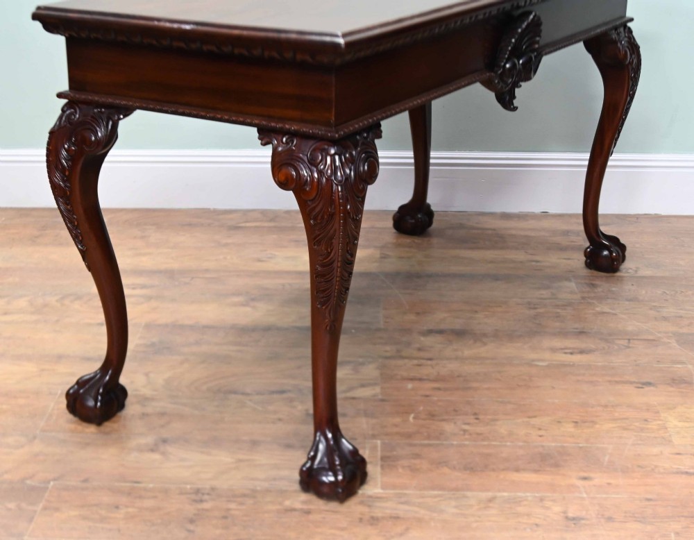 A rectangular Chippendale revival mahogany console table featuring a central carved apron shell detail, cabriole legs, and carved claw and ball feet. View IX