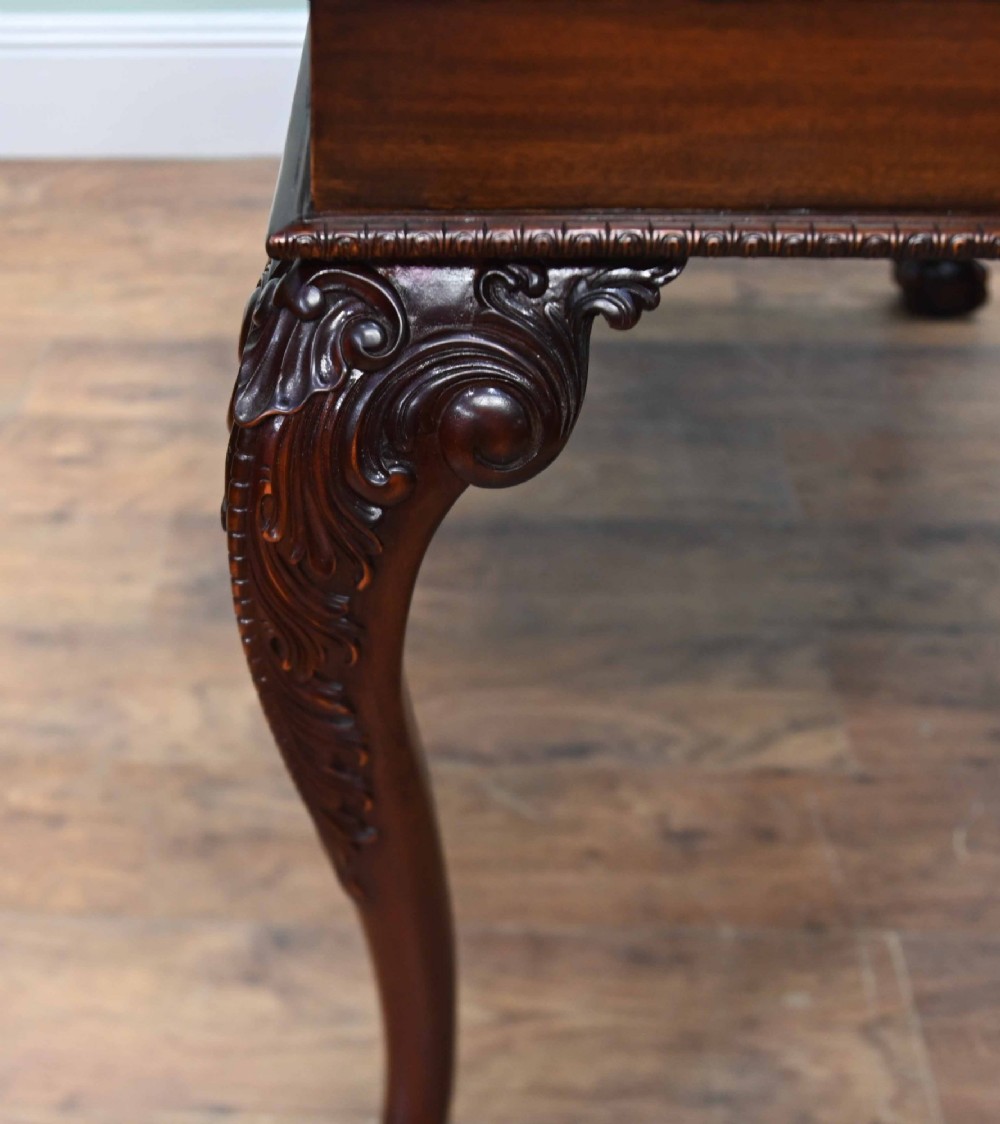 A rectangular Chippendale revival mahogany console table featuring a central carved apron shell detail, cabriole legs, and carved claw and ball feet. View XII