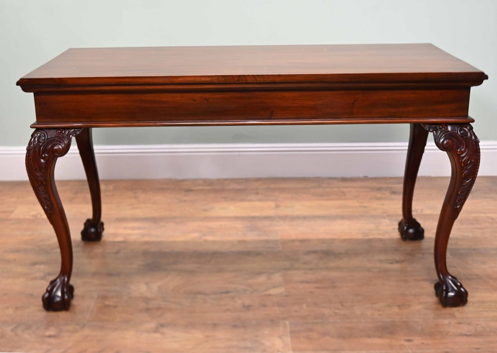 A rectangular Chippendale revival mahogany console table featuring a central carved apron shell detail, cabriole legs, and carved claw and ball feet. View XIII