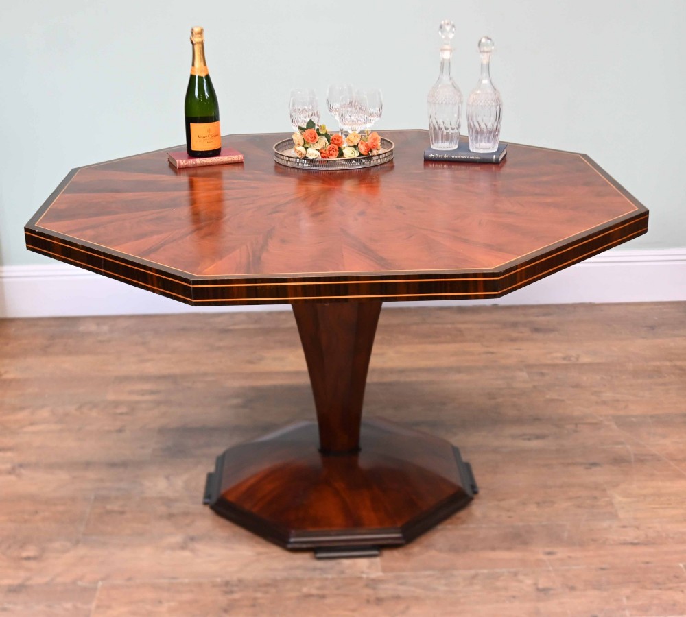 An octagonal Art Deco mahogany centre table featuring a sunburst veneer top, banded rim, and a tapered hexagonal pedestal base. View III