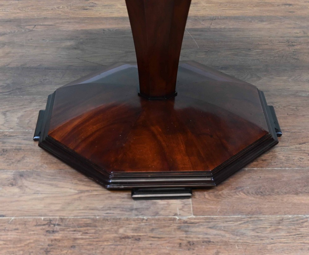 An octagonal Art Deco mahogany centre table featuring a sunburst veneer top, banded rim, and a tapered hexagonal pedestal base. View VI