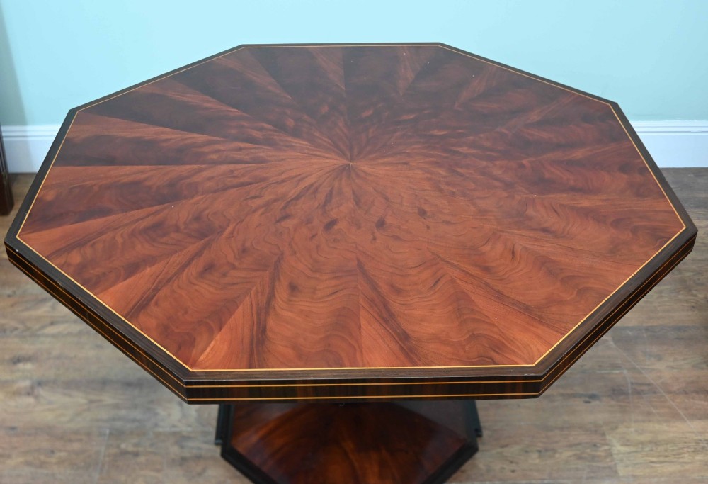 An octagonal Art Deco mahogany centre table featuring a sunburst veneer top, banded rim, and a tapered hexagonal pedestal base. View VIII