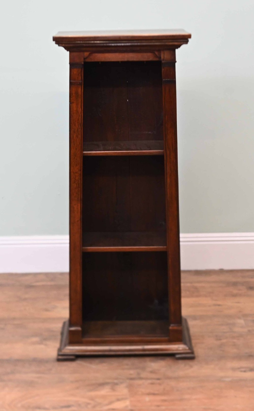 A tall, narrow late 19th-century dark oak open bookcase featuring fixed shelves, a moulded top cornice, and a sturdy plinth base. View IV