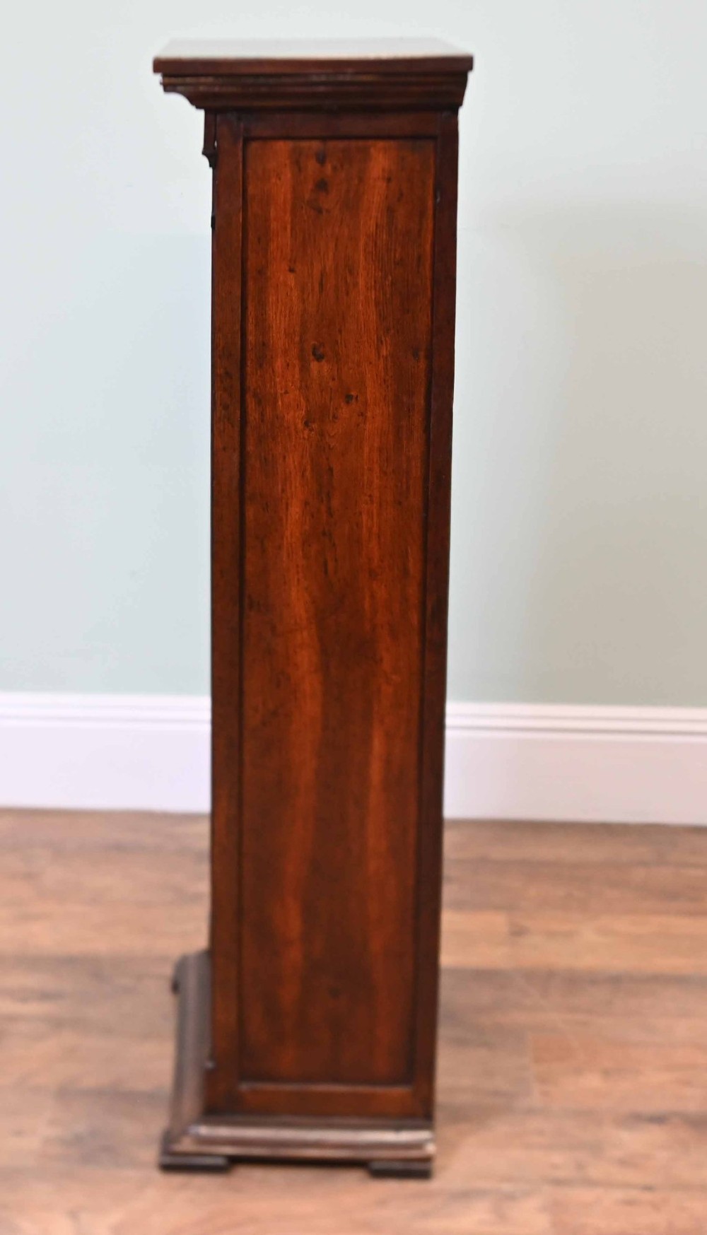 A tall, narrow late 19th-century dark oak open bookcase featuring fixed shelves, a moulded top cornice, and a sturdy plinth base. View VIII