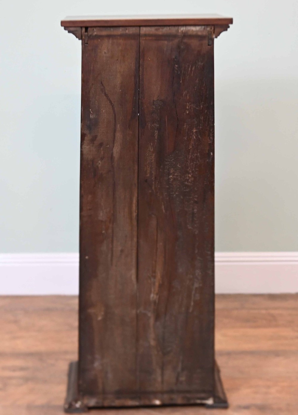 A tall, narrow late 19th-century dark oak open bookcase featuring fixed shelves, a moulded top cornice, and a sturdy plinth base. View IX