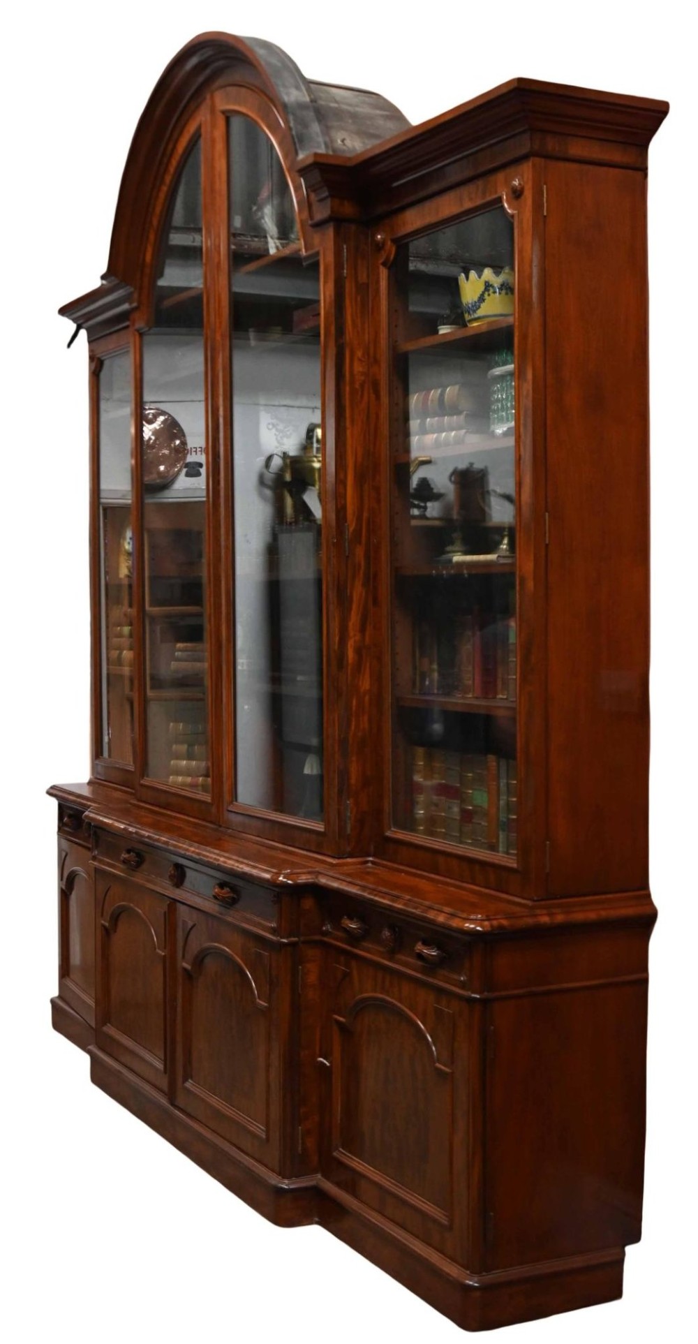 A large Victorian mahogany breakfront library bookcase featuring an arched central section with glazed upper doors over solid panelled cupboards. View III