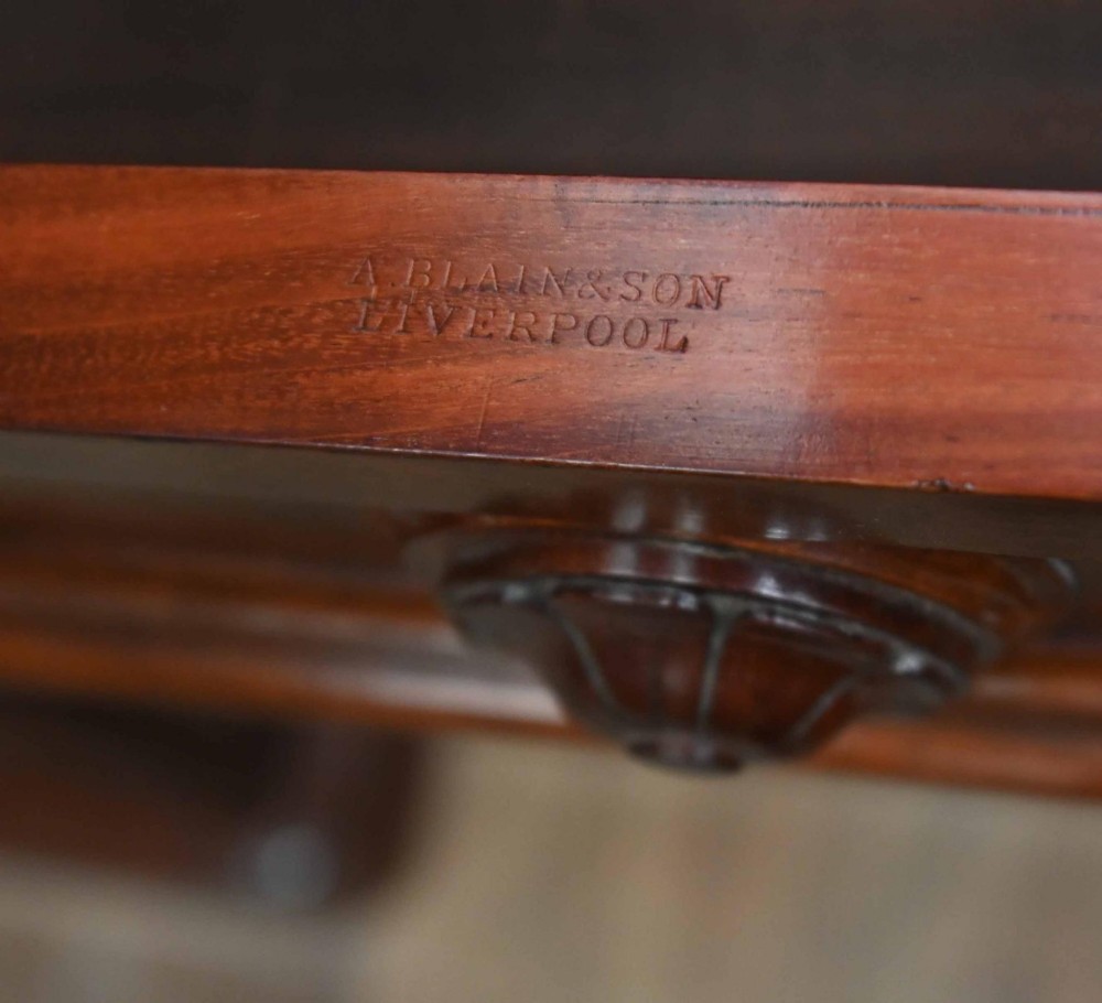 A large Victorian mahogany breakfront library bookcase featuring an arched central section with glazed upper doors over solid panelled cupboards. View IV