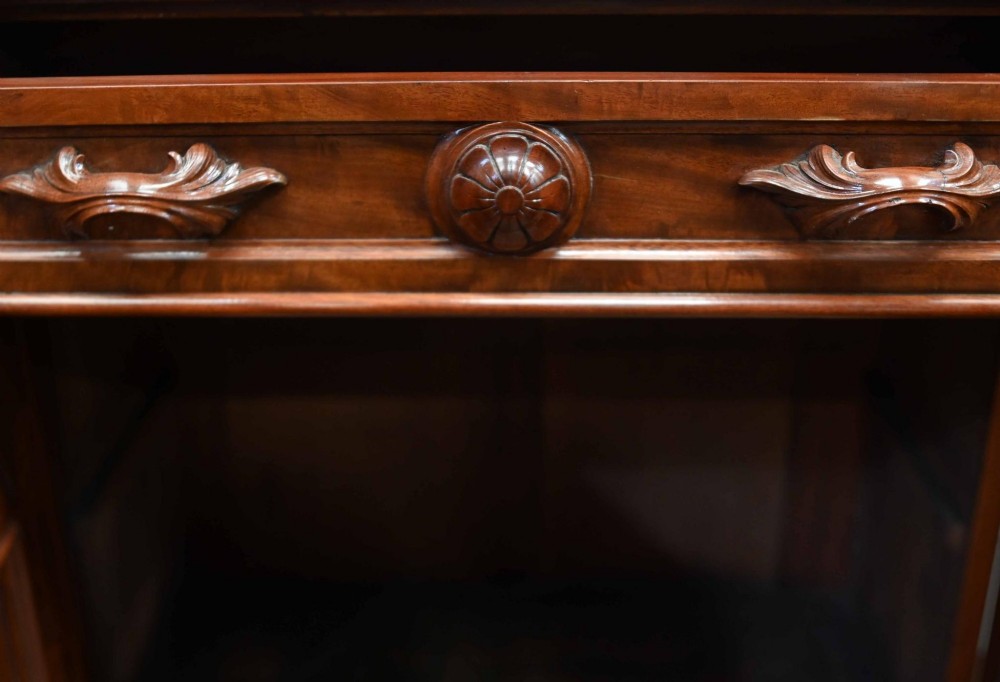 A large Victorian mahogany breakfront library bookcase featuring an arched central section with glazed upper doors over solid panelled cupboards. View IX