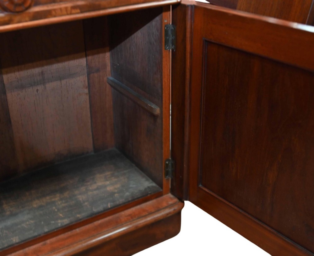 A large Victorian mahogany breakfront library bookcase featuring an arched central section with glazed upper doors over solid panelled cupboards. View XI