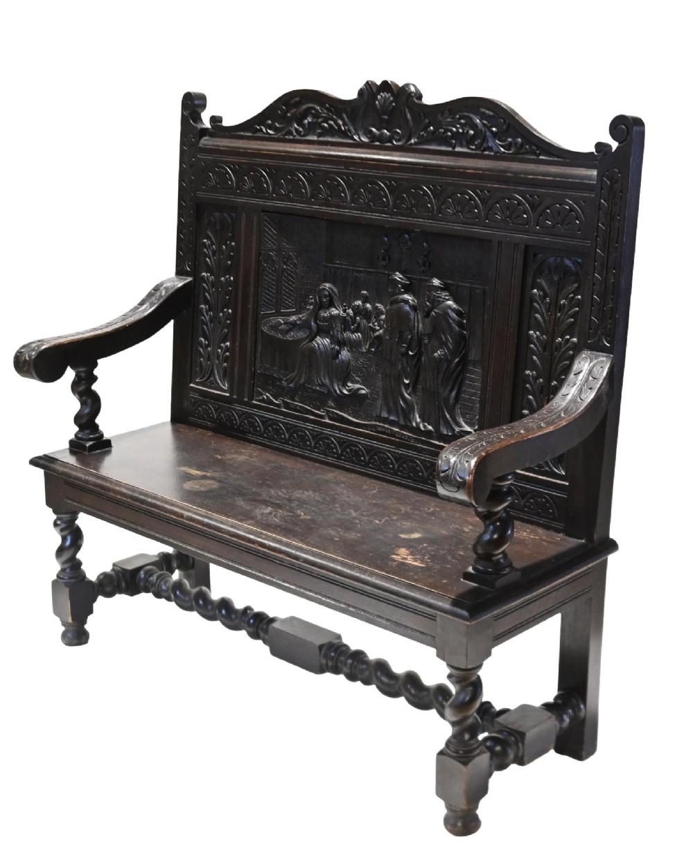 A late 19th-century dark carved walnut hall bench featuring a pictorial relief back panel, scrolled armrests, and turned stretchers. View VIII