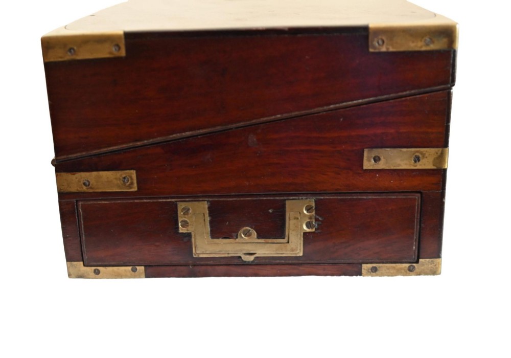 A rectangular warm brown mahogany wooden writing slope box featuring brass corner brackets and a shaped brass keyhole escutcheon. View V