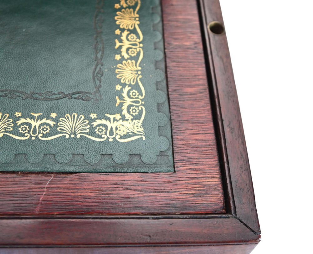 A rectangular warm brown mahogany wooden writing slope box featuring brass corner brackets and a shaped brass keyhole escutcheon. View IX