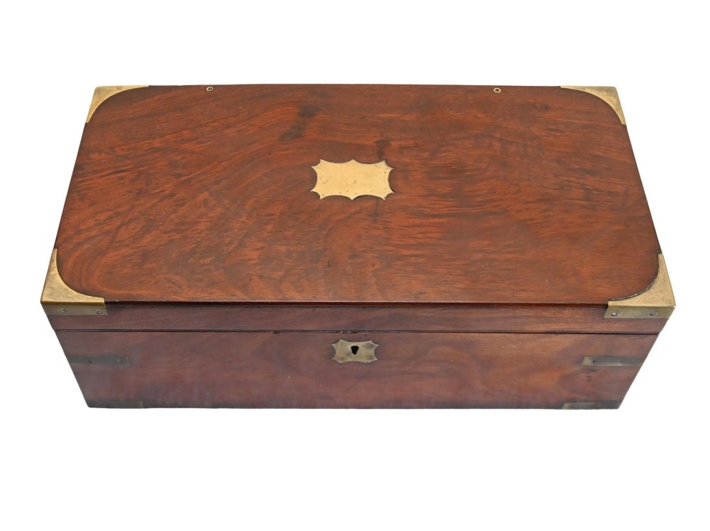 A rectangular warm brown mahogany wooden writing slope box featuring brass corner brackets and a shaped brass keyhole escutcheon. View X