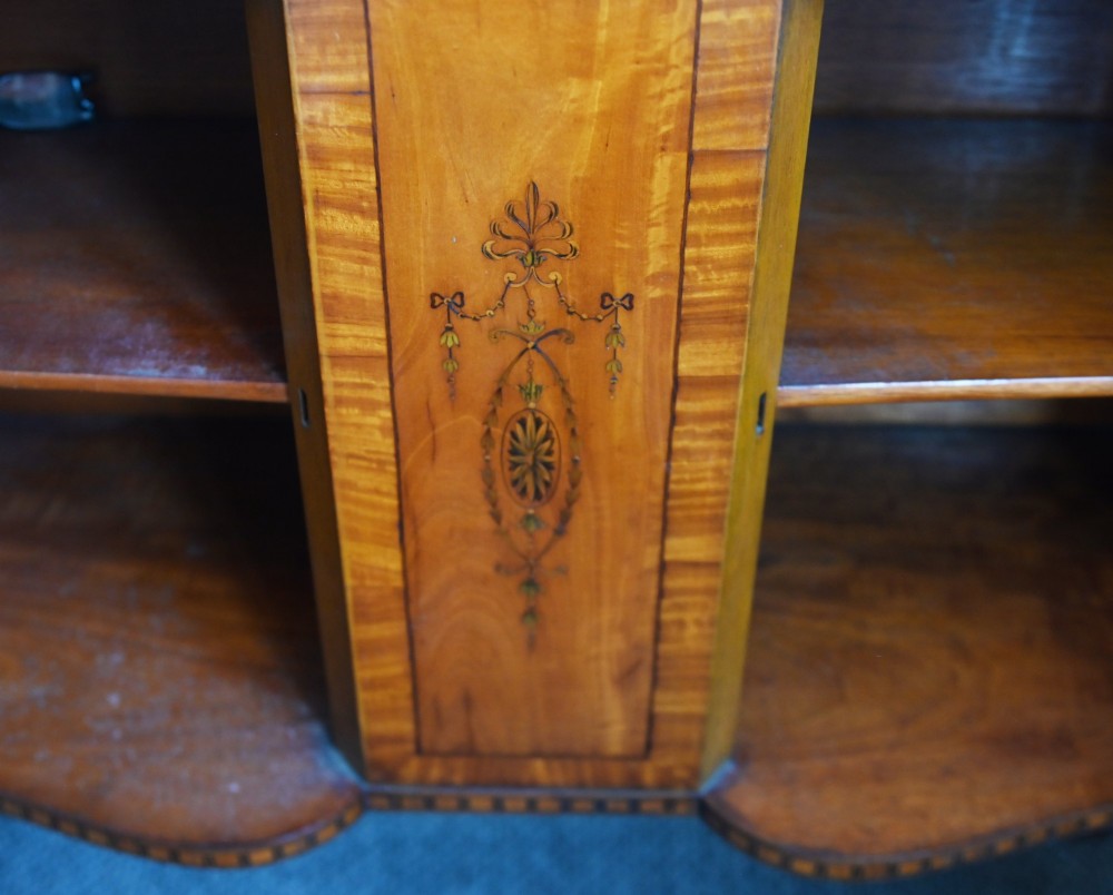 An Edwardian Sheraton Revival display cabinet in painted satinwood with glazed double doors, decorative oval glazing bars, and lower cupboard doors on slender square legs. View XII