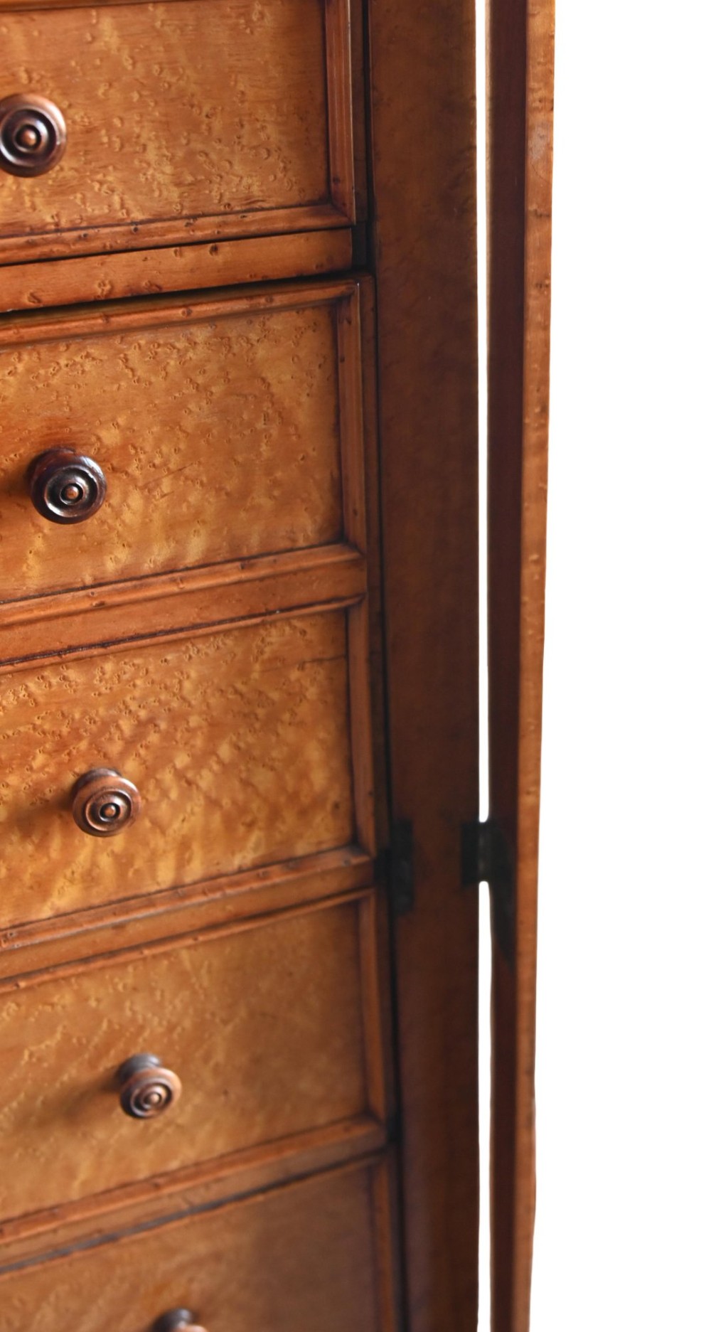 A tall Victorian birds eye maple Wellington chest featuring seven drawers with turned wooden knobs and a side locking flap. View VI