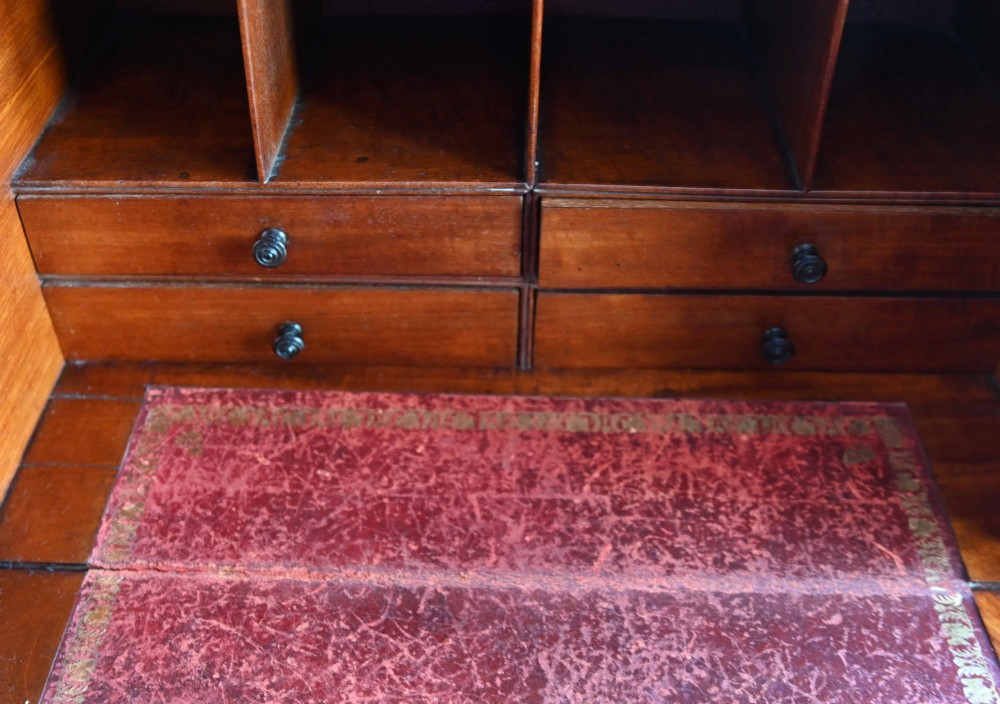 A tall Victorian birds eye maple Wellington chest featuring seven drawers with turned wooden knobs and a side locking flap. View XI
