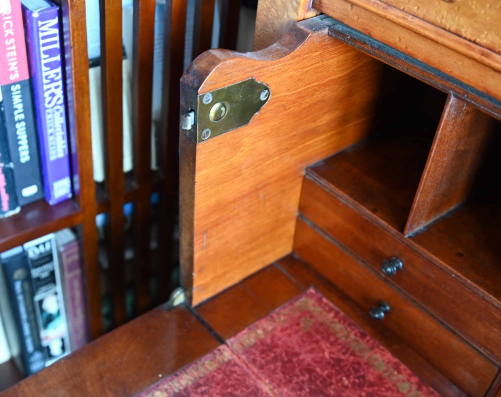 A tall Victorian birds eye maple Wellington chest featuring seven drawers with turned wooden knobs and a side locking flap. View XIII