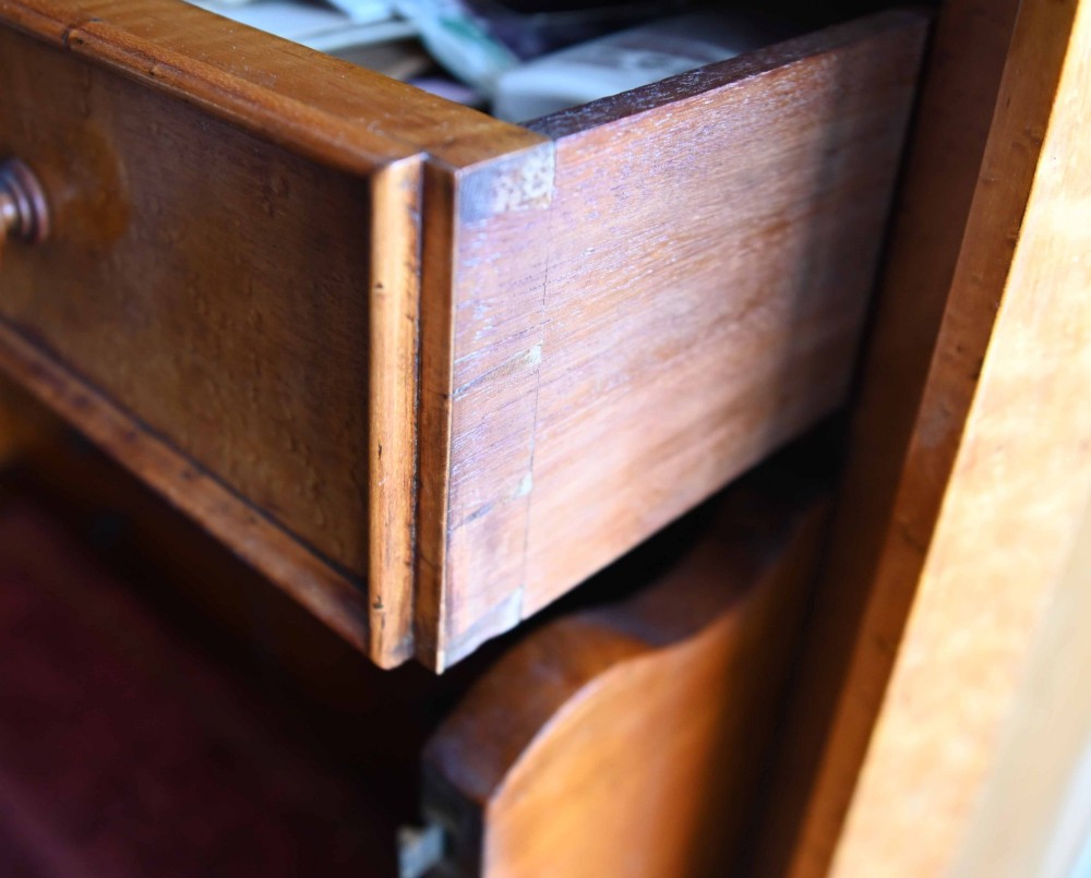 A tall Victorian birds eye maple Wellington chest featuring seven drawers with turned wooden knobs and a side locking flap. View XIV