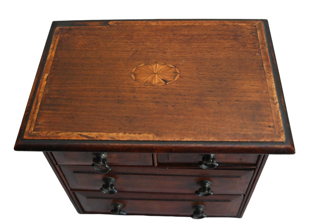 A Georgian Revival mahogany apprentice chest featuring two small top drawers over two full-width drawers with brass drop handles and an inlaid top border. View IV