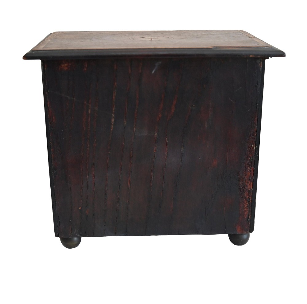 A Georgian Revival mahogany apprentice chest featuring two small top drawers over two full-width drawers with brass drop handles and an inlaid top border. View VII