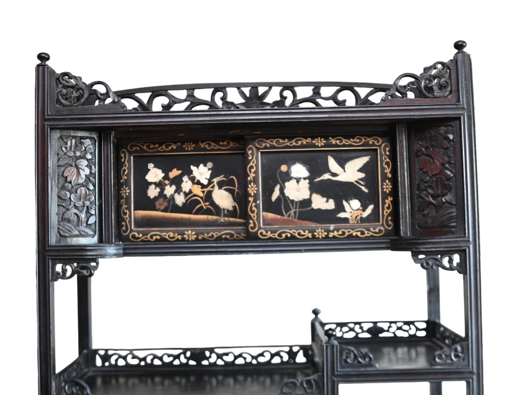 An antique ebonised Chinese display cabinet featuring asymmetrical shelves, pierced fretwork, and panels decorated with mother-of-pearl crane and botanical inlays. View IV