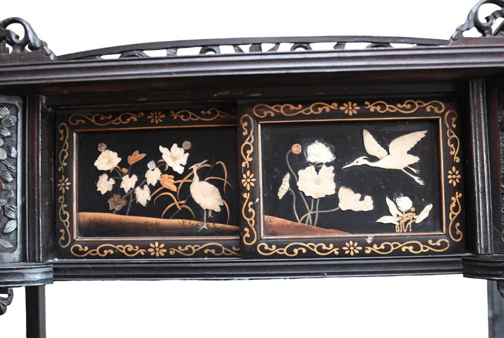 An antique ebonised Chinese display cabinet featuring asymmetrical shelves, pierced fretwork, and panels decorated with mother-of-pearl crane and botanical inlays. View VII