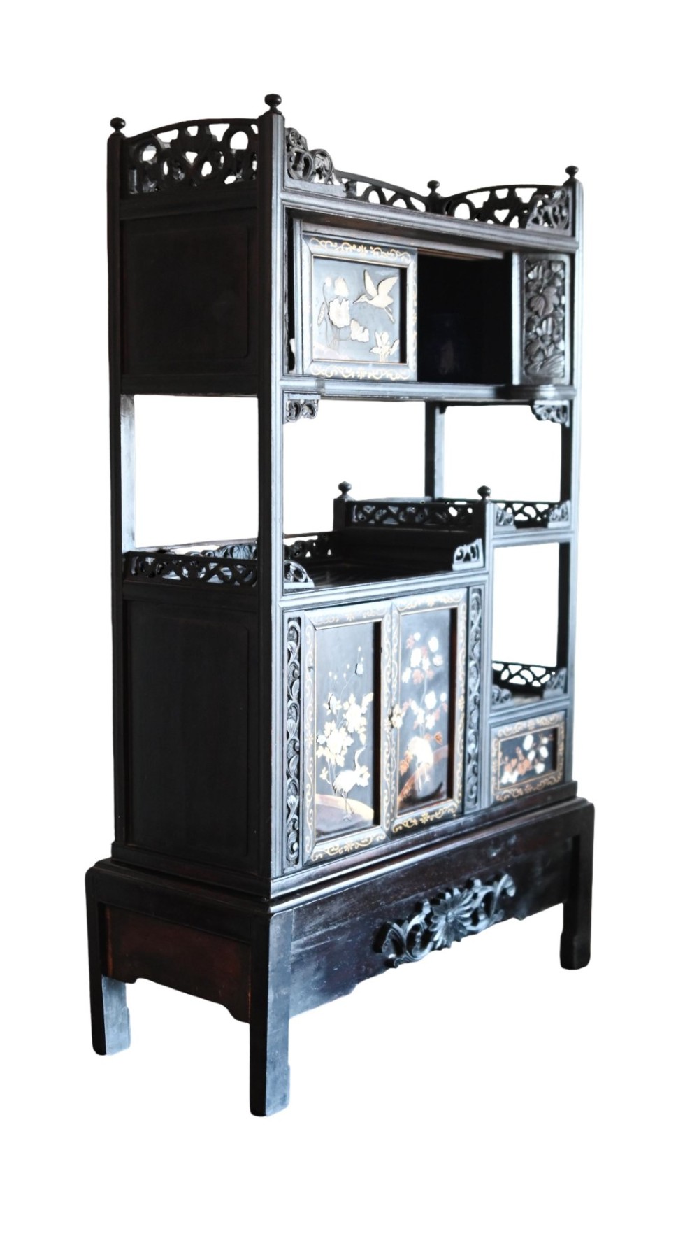 An antique ebonised Chinese display cabinet featuring asymmetrical shelves, pierced fretwork, and panels decorated with mother-of-pearl crane and botanical inlays. View X