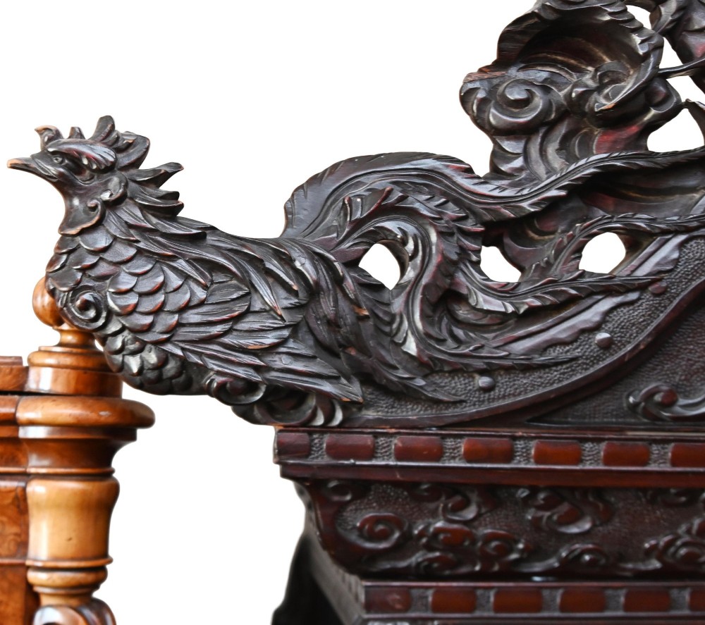 An intricately carved dark hardwood Japanese Meiji display cabinet featuring a dragon pediment, glazed door, and tiered asymmetrical shelves. View IV
