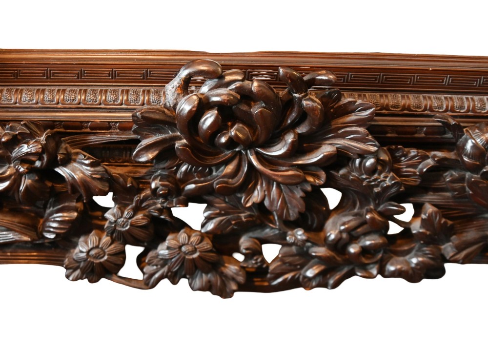 An intricately carved dark hardwood Japanese Meiji display cabinet featuring a dragon pediment, glazed door, and tiered asymmetrical shelves. View VIII
