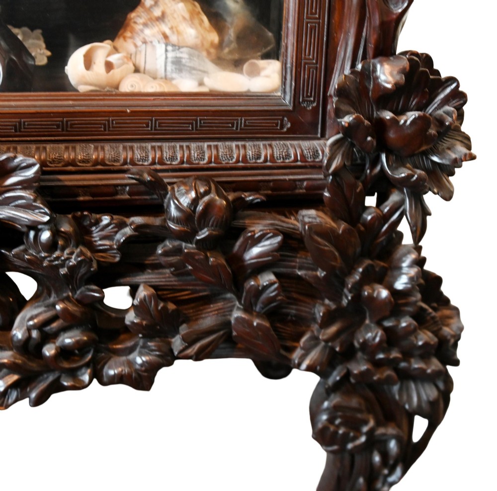 An intricately carved dark hardwood Japanese Meiji display cabinet featuring a dragon pediment, glazed door, and tiered asymmetrical shelves. View IX