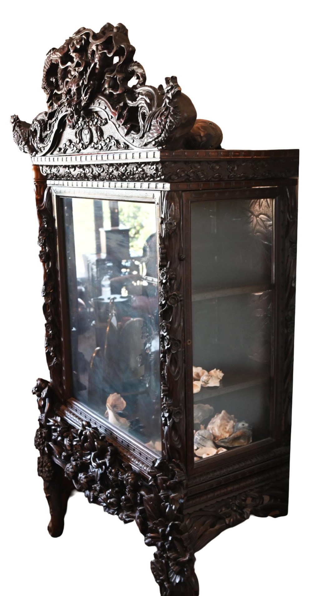 An intricately carved dark hardwood Japanese Meiji display cabinet featuring a dragon pediment, glazed door, and tiered asymmetrical shelves. View XI