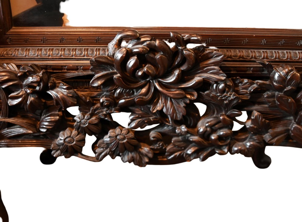 An intricately carved dark hardwood Japanese Meiji display cabinet featuring a dragon pediment, glazed door, and tiered asymmetrical shelves. View XIV