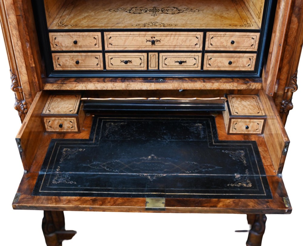 A tall 19th-century French Louis Philippe secretaire desk featuring figured birds-eye maple veneer, carved wooden handles, upper cabinet doors, and finials on top. View XII