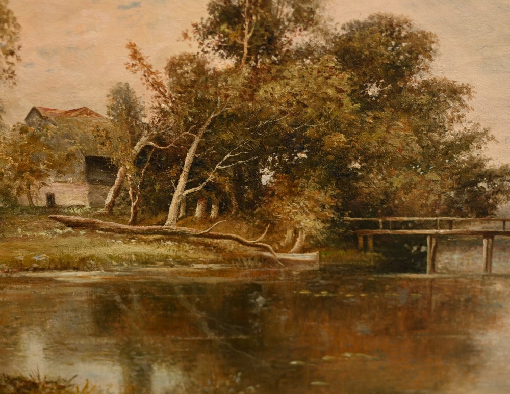 A 19th-century Victorian oil painting depicting a river landscape with trees and a wooden bridge, housed in a moulded gold gilt frame. View III
