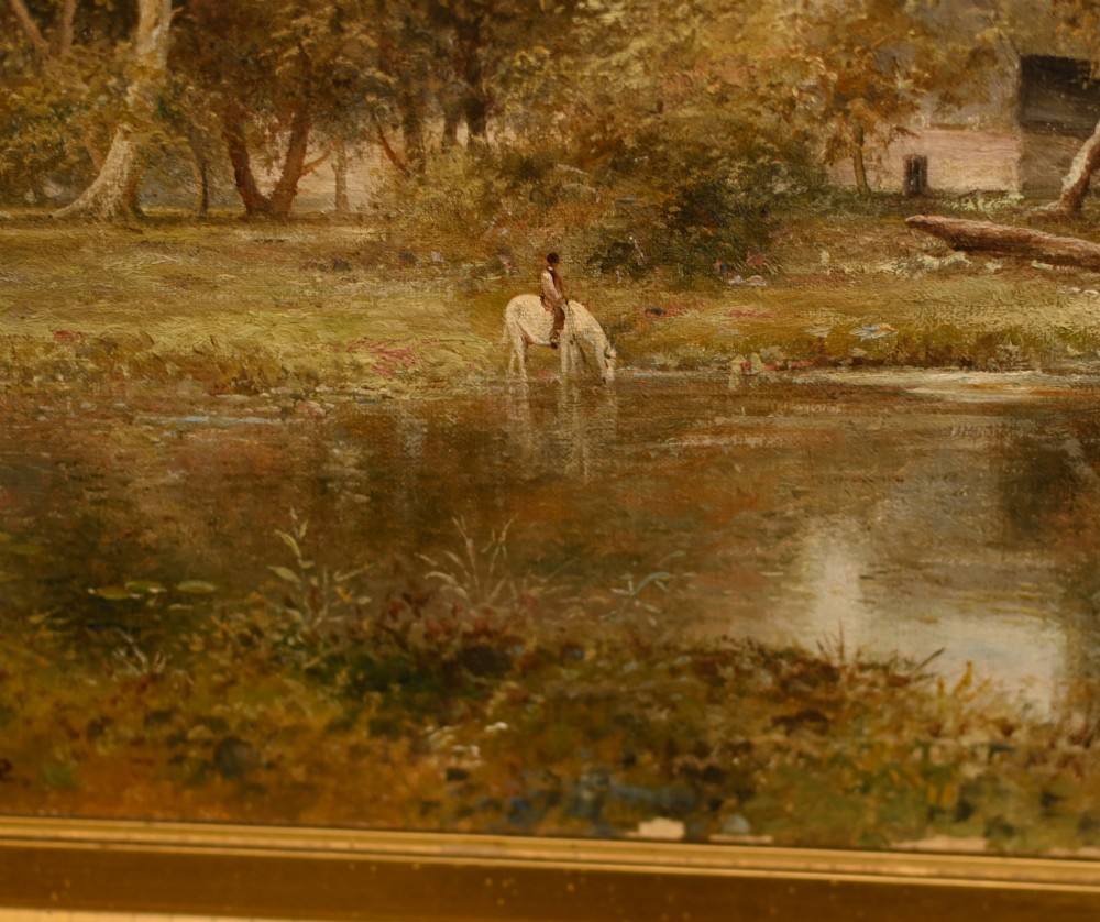A 19th-century Victorian oil painting depicting a river landscape with trees and a wooden bridge, housed in a moulded gold gilt frame. View IV