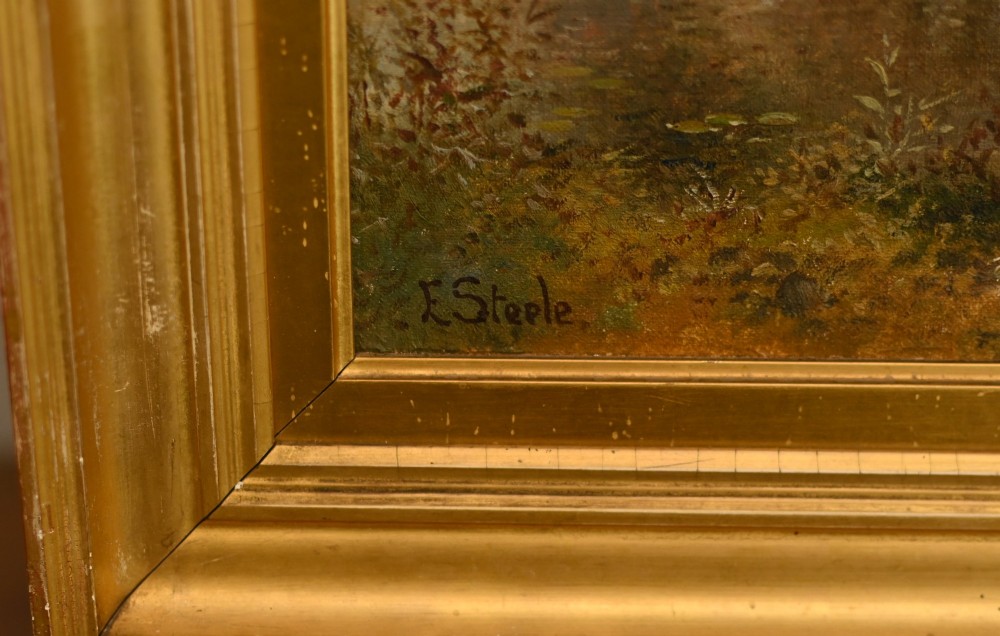 A 19th-century Victorian oil painting depicting a river landscape with trees and a wooden bridge, housed in a moulded gold gilt frame. View V