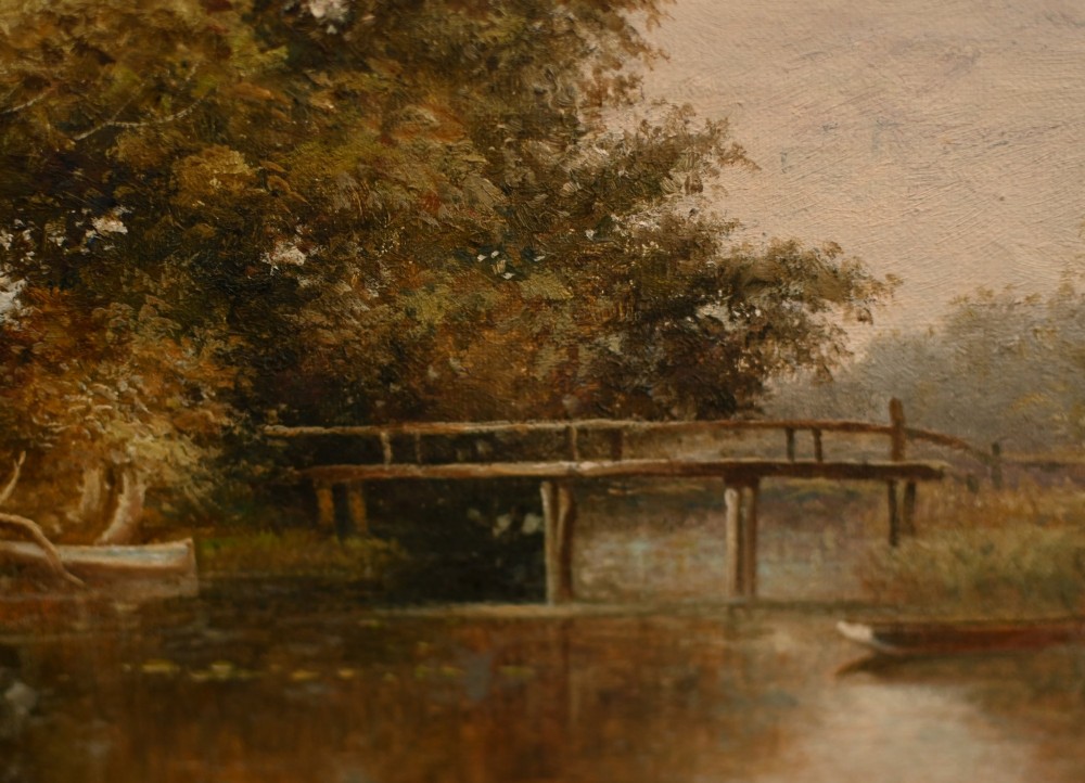 A 19th-century Victorian oil painting depicting a river landscape with trees and a wooden bridge, housed in a moulded gold gilt frame. View VI
