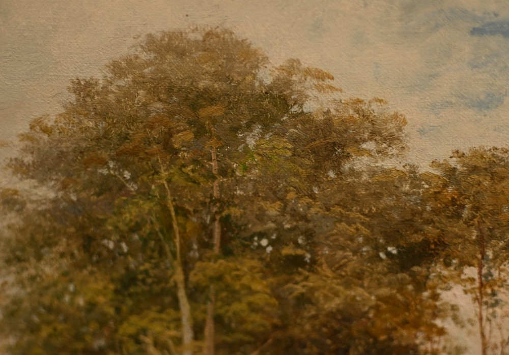 A 19th-century Victorian oil painting depicting a river landscape with trees and a wooden bridge, housed in a moulded gold gilt frame. View VIII