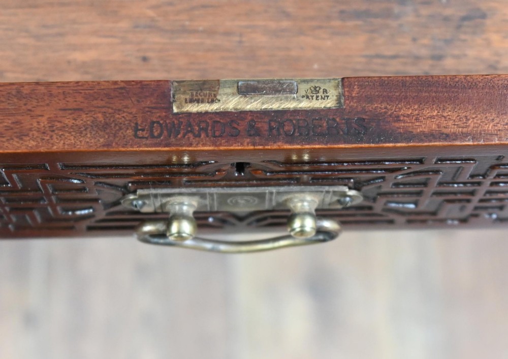 A mahogany ladies writing desk featuring a red leather inset writing surface, a central mirror superstructure flanked by drawers, and turned legs on castors. View VI