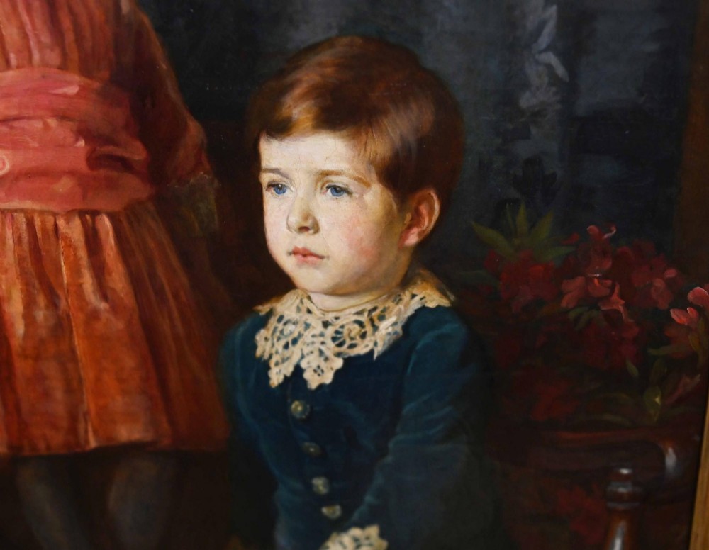 An 1887 Victorian oil portrait painting depicting two young children in period attire seated on a carved wooden bench within a gilt wood frame. View VI