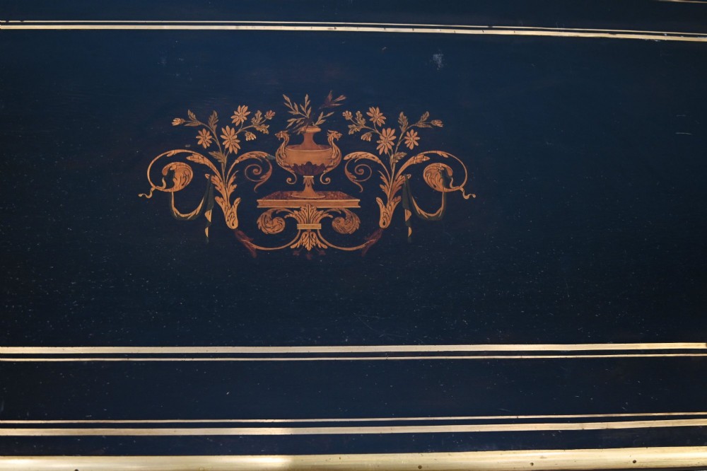 A late 19th-century French Napoleon III ebonised card table featuring floral marquetry inlay on the top and frieze with brass borders and tapered fluted legs. View III