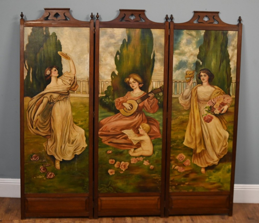 A Victorian three-panel mahogany folding screen featuring hand-painted figures in classical garments set against a garden background.