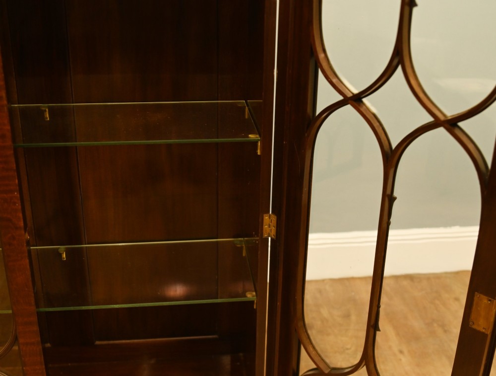 A Chippendale Revival mahogany display cabinet featuring three astragal glazed doors and carved ball and claw feet. View IV