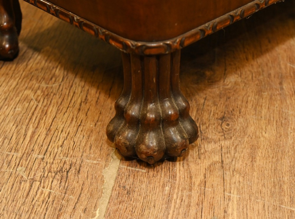A Chippendale Revival mahogany display cabinet featuring three astragal glazed doors and carved ball and claw feet. View VII
