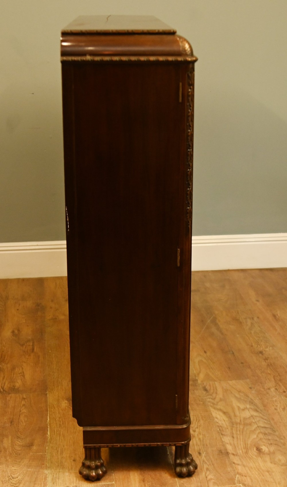 A Chippendale Revival mahogany display cabinet featuring three astragal glazed doors and carved ball and claw feet. View IX