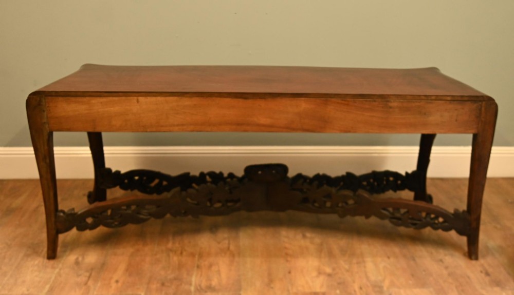 A dark hardwood Qing Dynasty console table featuring intricate carved openwork aprons and scrolled cabriole legs. View VIII