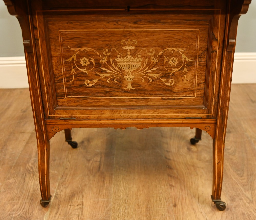 An Edwardian mahogany Davenport desk with urn marquetry inlays, a leather writing slope, brass gallery rim, and legs on castors. View III
