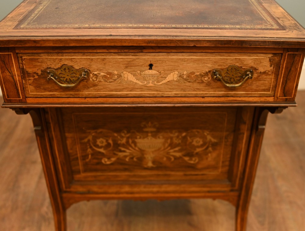 An Edwardian mahogany Davenport desk with urn marquetry inlays, a leather writing slope, brass gallery rim, and legs on castors. View IV