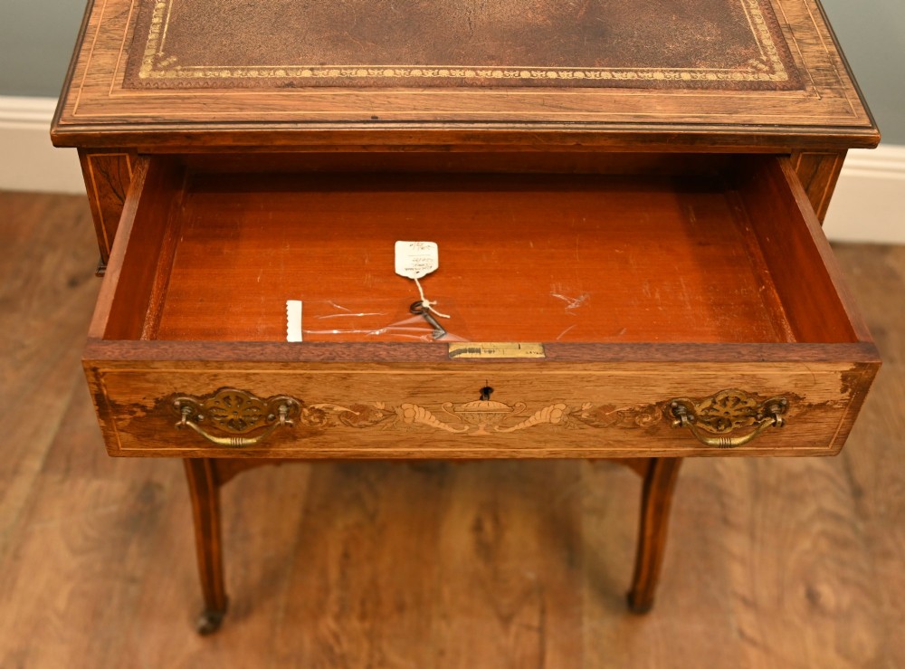 An Edwardian mahogany Davenport desk with urn marquetry inlays, a leather writing slope, brass gallery rim, and legs on castors. View X